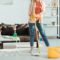 Cropped view of woman cleaning house with mop and bucket