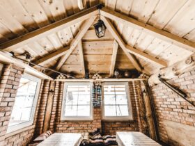 interior of wooden rural cottage with windows and brick walls