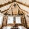 interior of wooden rural cottage with windows and brick walls