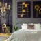 Plants and black and gold posters in grey bedroom interior with