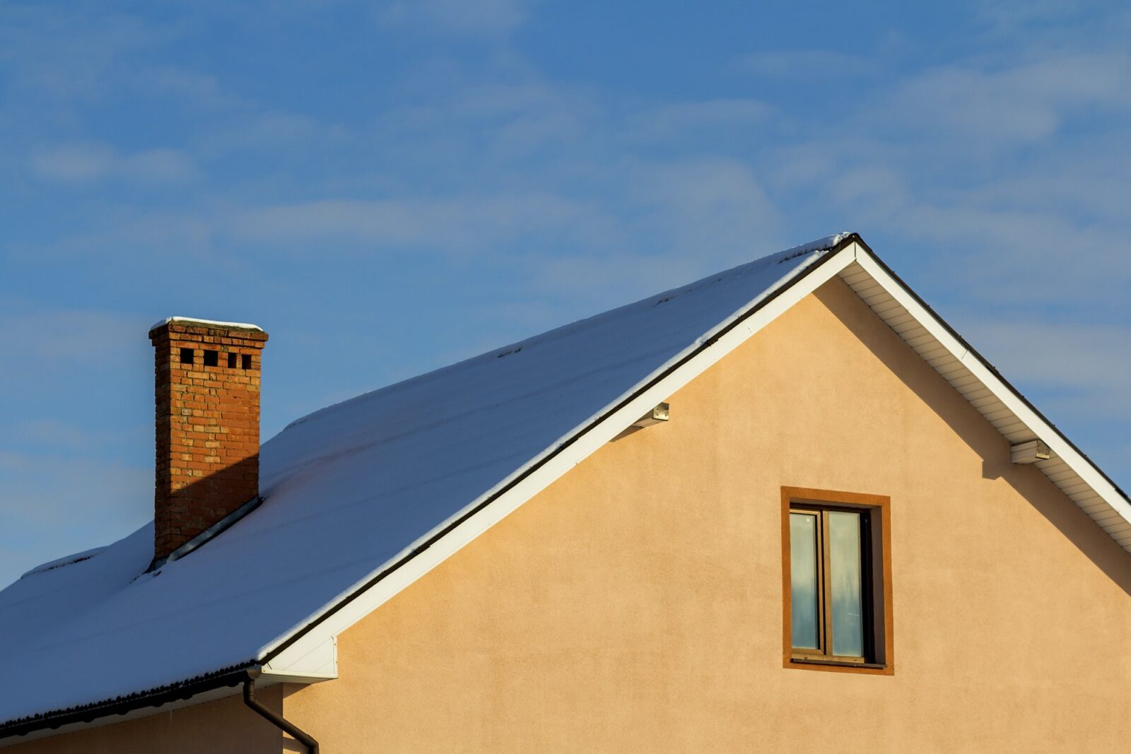 Roof of a new built house with nice window and chimney