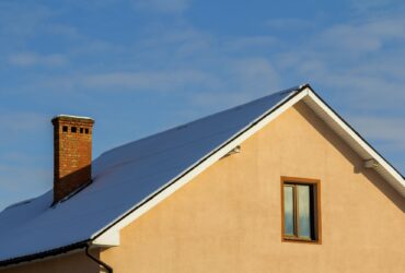 Roof of a new built house with nice window and chimney