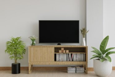 The living room has a storage table and a TV.