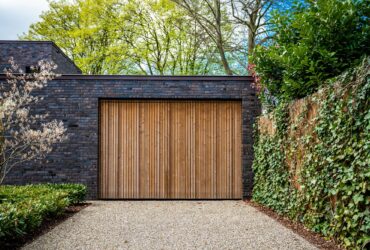 wide garage door and concrete driveway in front