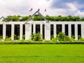 Asia botanic garden building exterior and green grass lawn with plant and flags on roof top