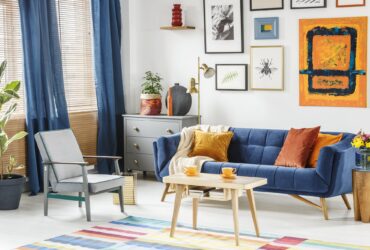 Bright and cozy living room interior with blue drapes, a sofa wi