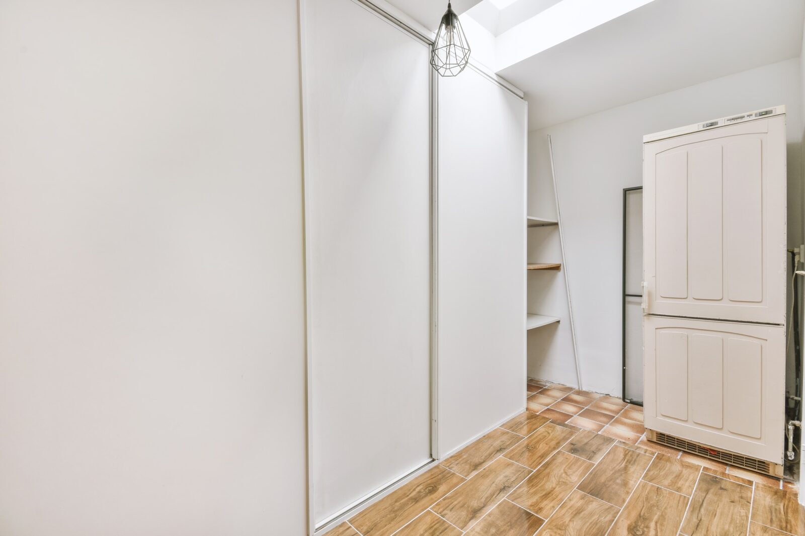 Empty narrow room with storage spaces