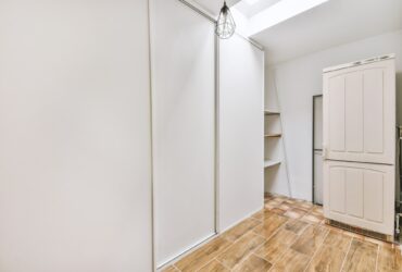 Empty narrow room with storage spaces
