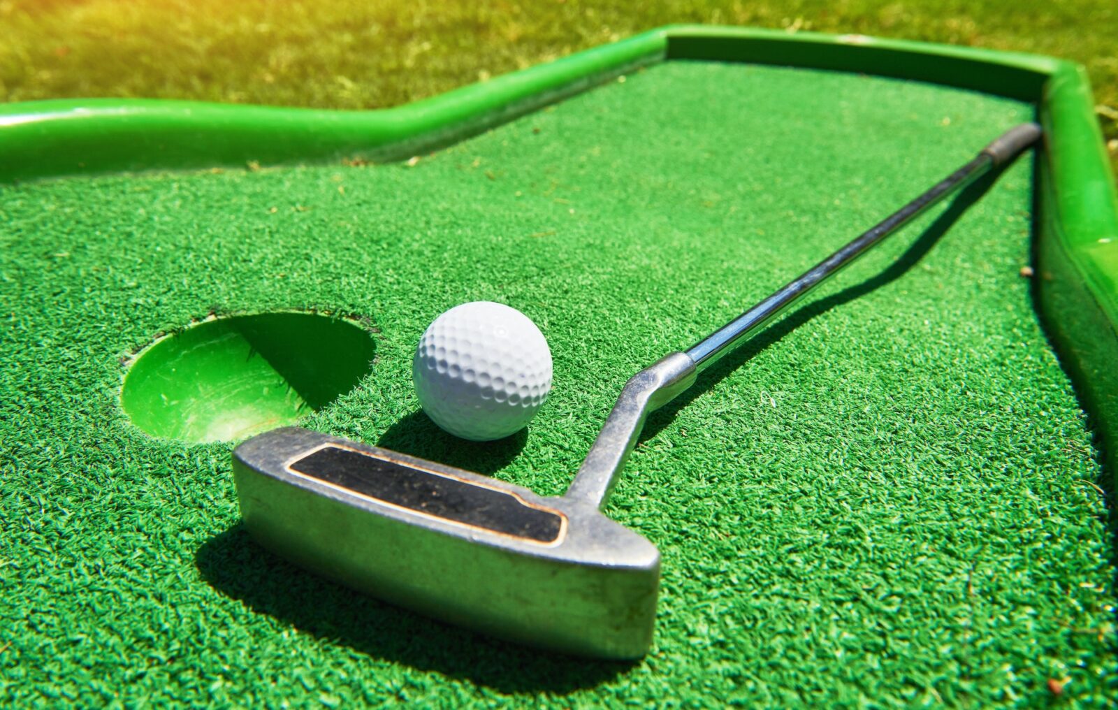 Golf ball and Golf Club on Artificial Grass