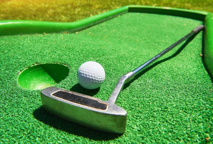 Golf ball and Golf Club on Artificial Grass