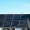 Newly build houses with solar panels attached on the roof against a sunny sky