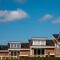 Newly build houses with solar panels attached on the roof against a sunny sky