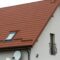 Roof of a new house made from yellow roofing tiles
