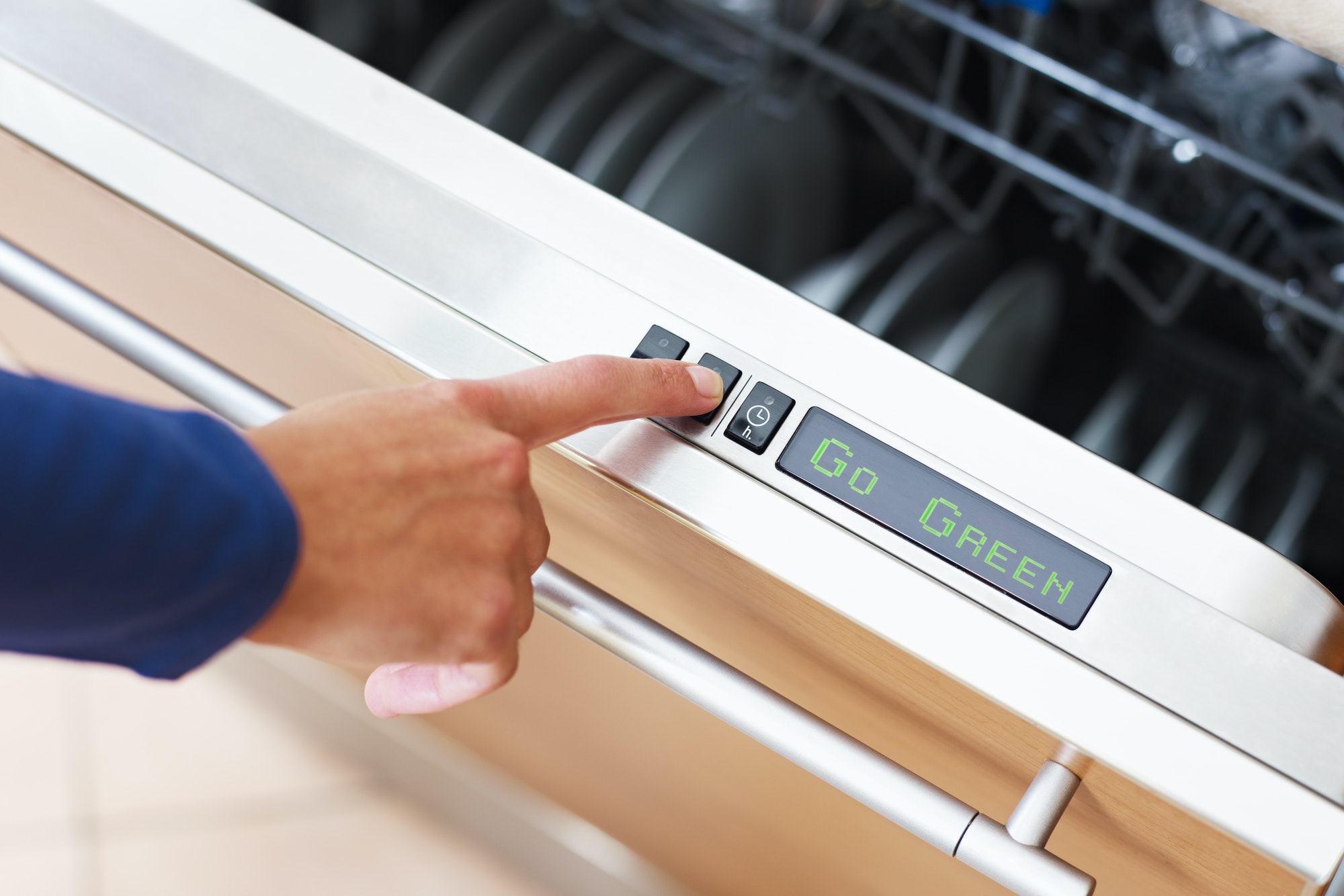 woman pressing energy saver button on dishwasher