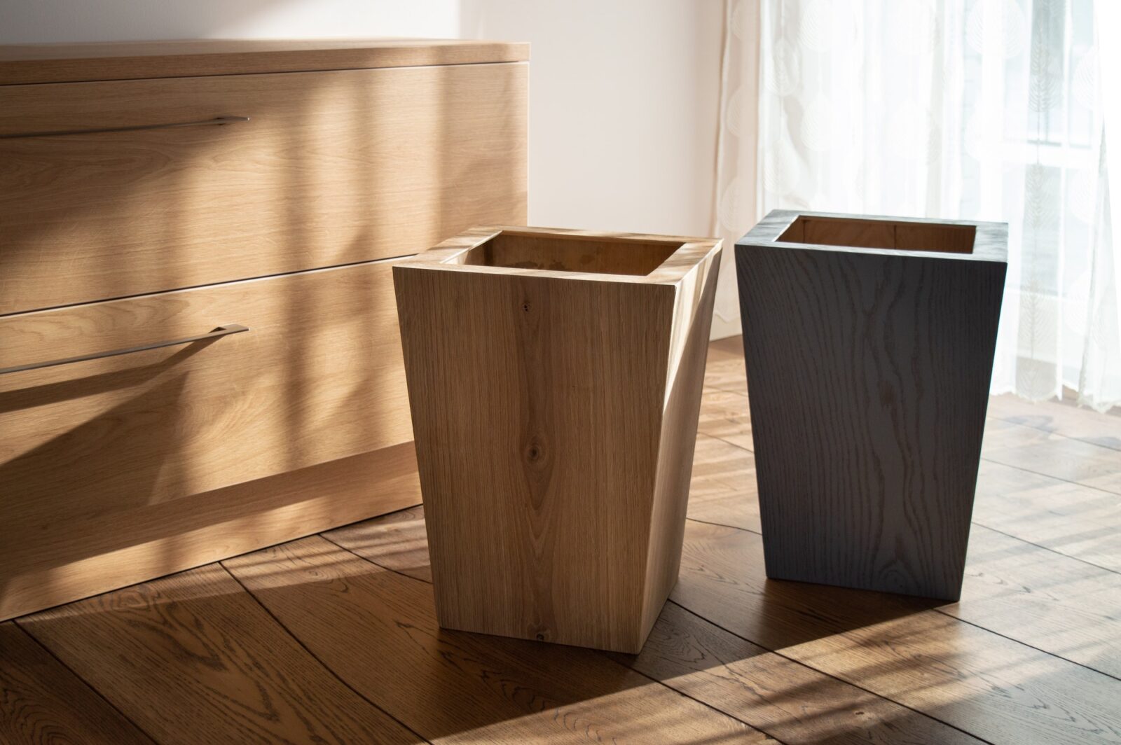 Wooden tall flower pots in natural wooden interior with natural wood furniture and oak floor