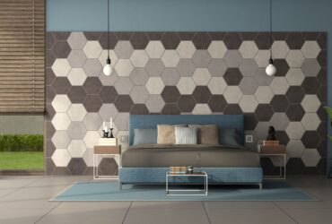 Blue sofa in front of a wall with hexagonal wooden tiles