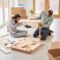 Couple In New Home On Moving Day Putting Together Self Assembly Furniture