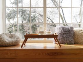 Large window with a window sill with hot tea and cups. The concept of rest and relaxation