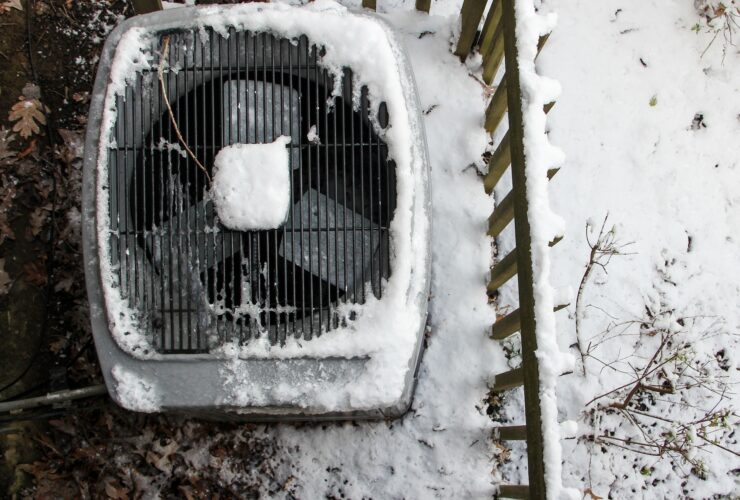 Overhead view of Central Air Conditioner HVAC unit covered with snow after snowstorm