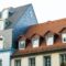 Roofs of old houses with roof windows and orange roof tiles in German city