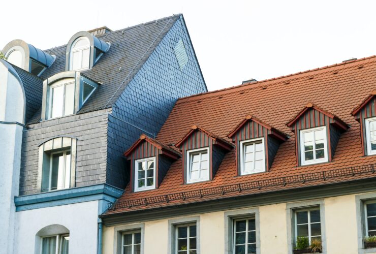 Roofs of old houses with roof windows and orange roof tiles in German city
