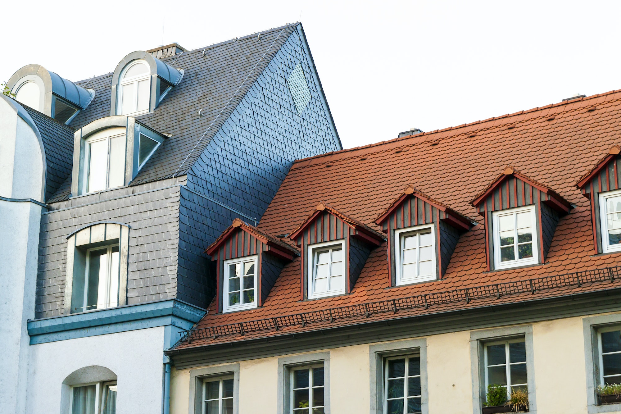 Roofs of old houses with roof windows and orange roof tiles in German city