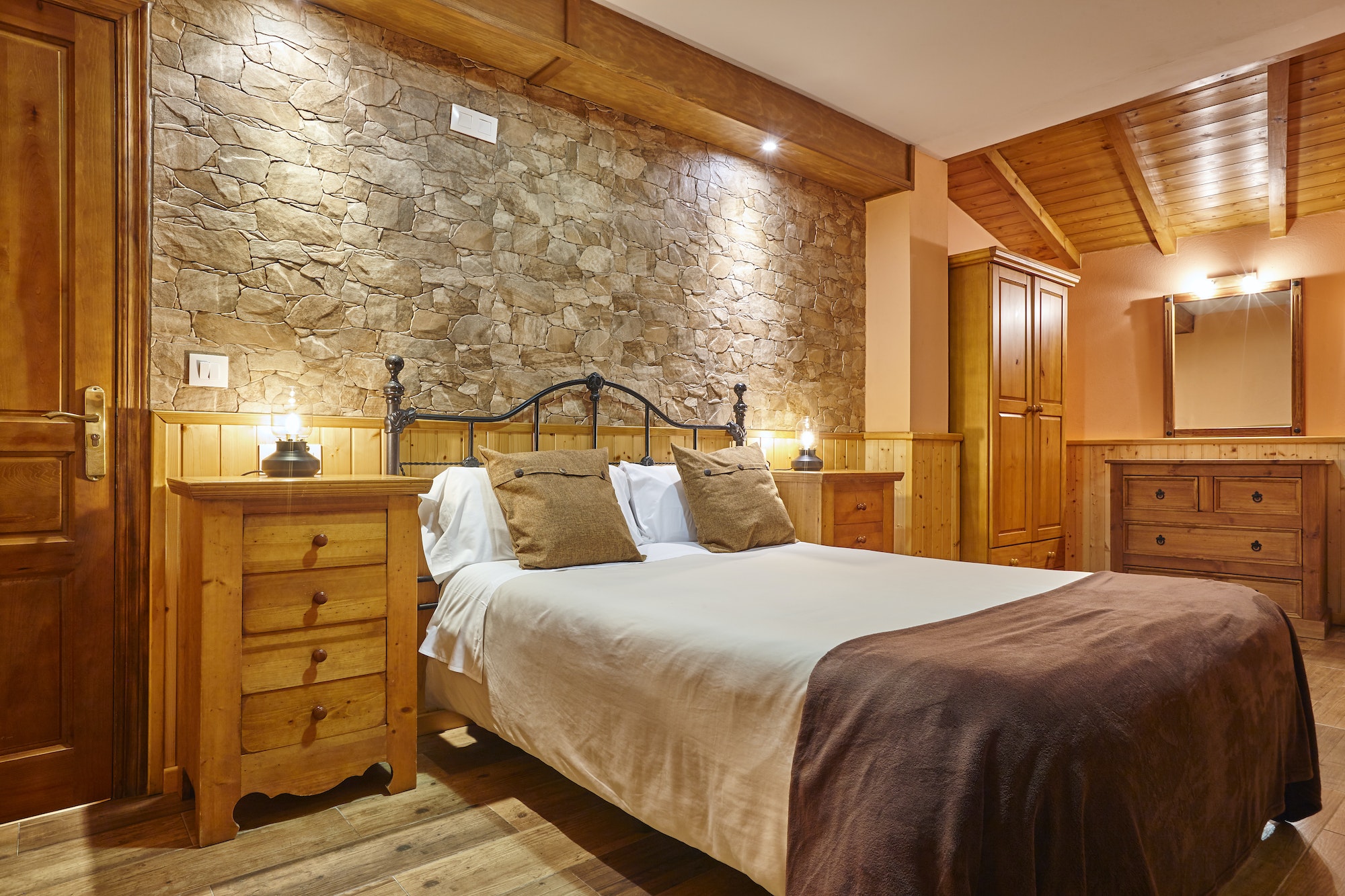 Rustic style bedroom indoor. Wood and stone decoration. Nobody
