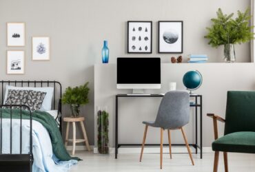 Branches of spruce in glass vases in classy bedroom and workspac