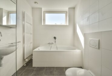 Interior of modern restroom with bathtub