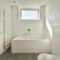 Interior of modern restroom with bathtub