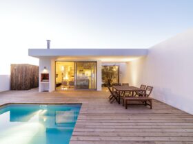 Modern house with garden swimming pool and wooden deck