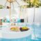 Breakfast and afternoon tea set floating around swimming pool