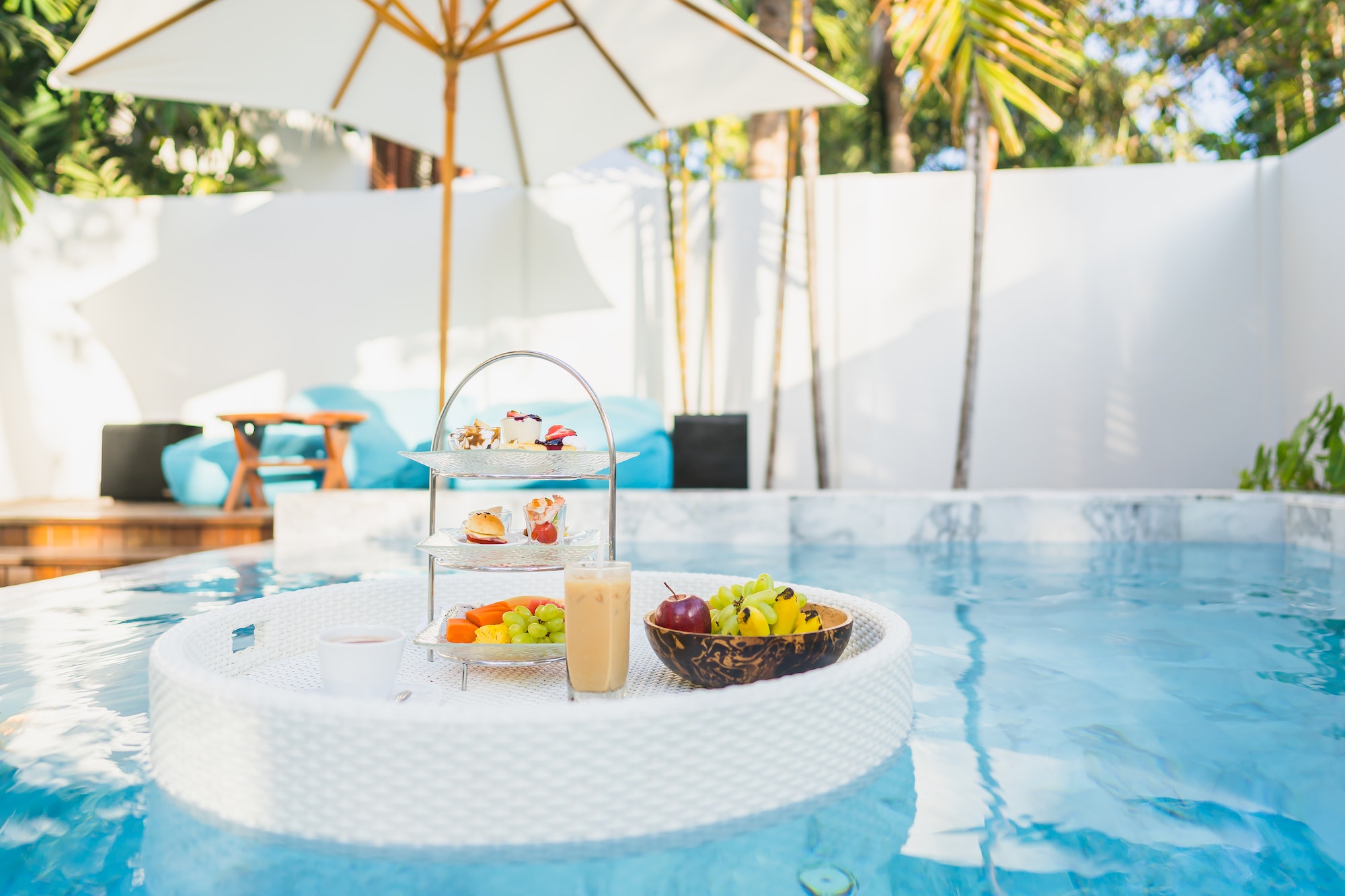 Breakfast and afternoon tea set floating around swimming pool