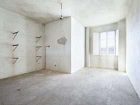 Empty, dirty room in old house, white walls