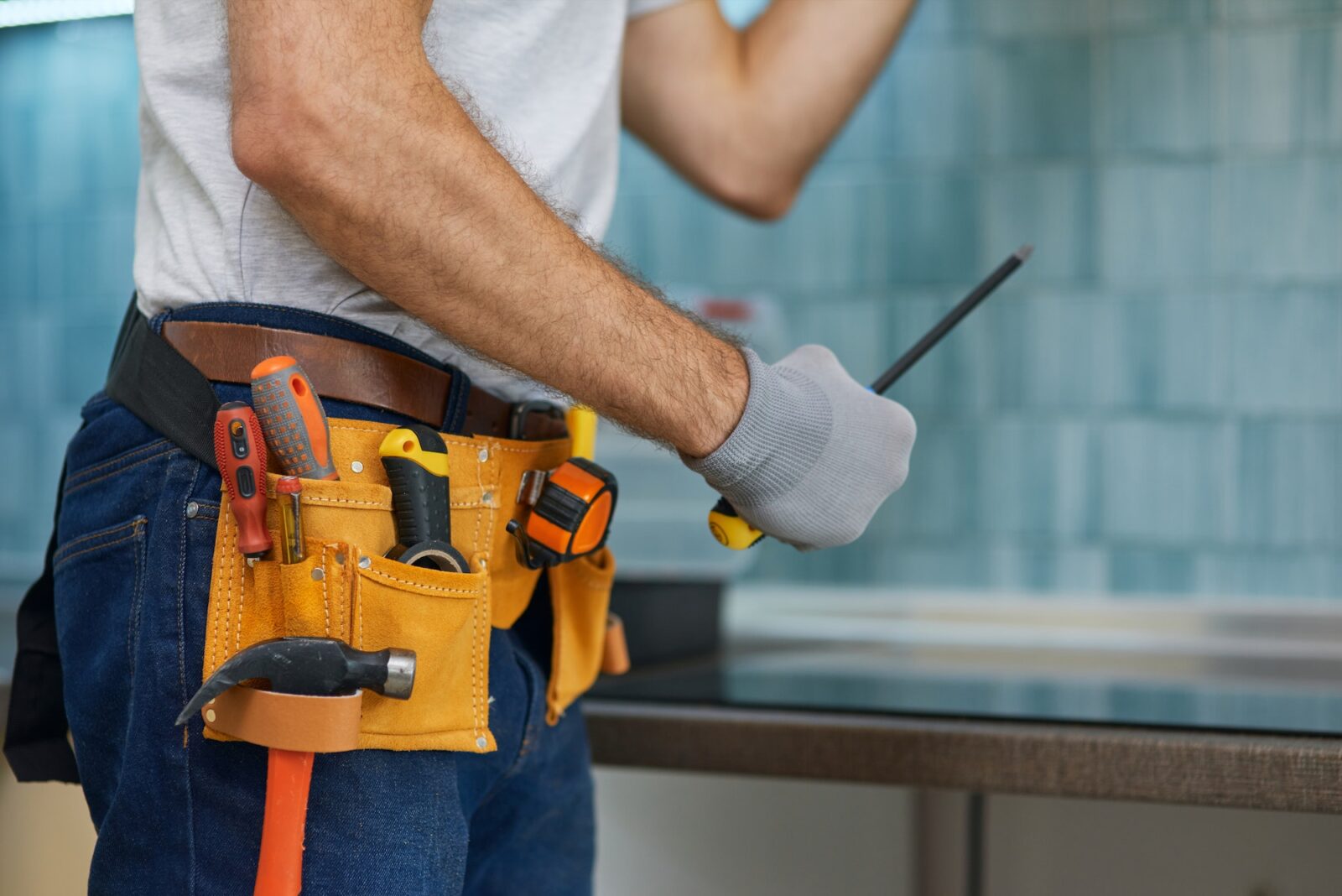 Expert. Cropped shot of young repairman, professional plumber holding a screwdriver while fixing a
