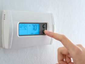 Hand press indoor room thermostat to lower the temp
