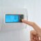 Hand press indoor room thermostat to lower the temp