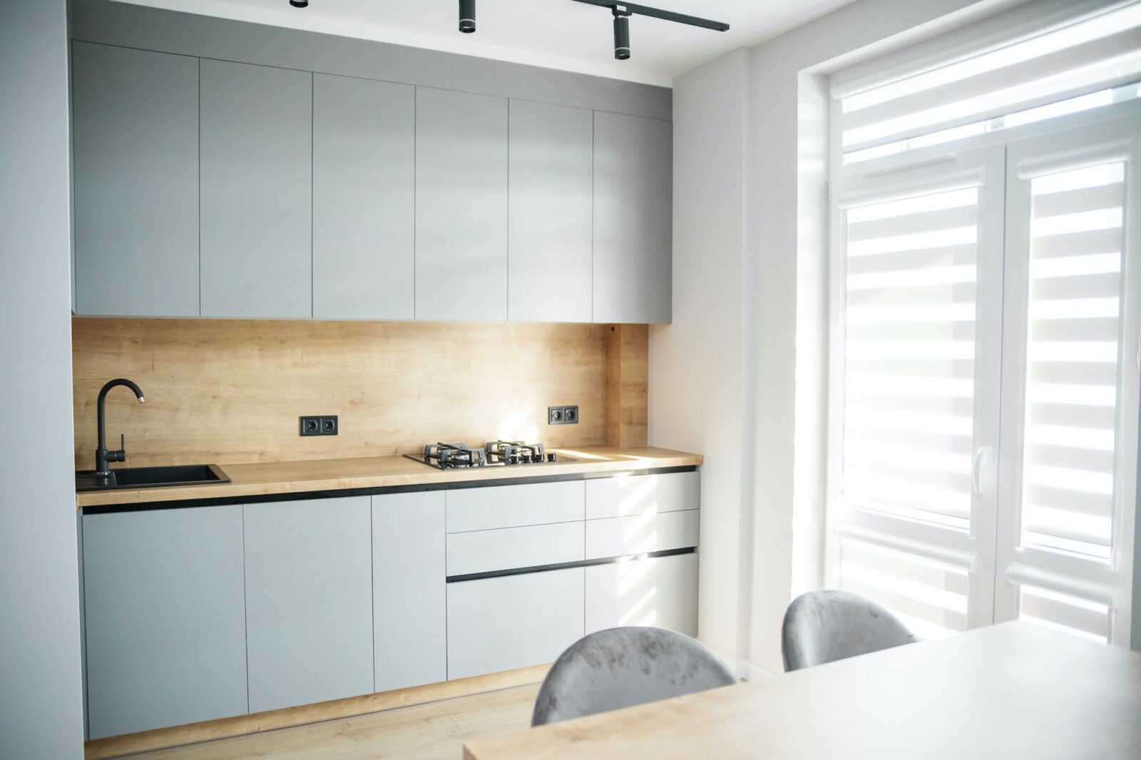 Light modern kitchen interior with gray tones. Cozy home.