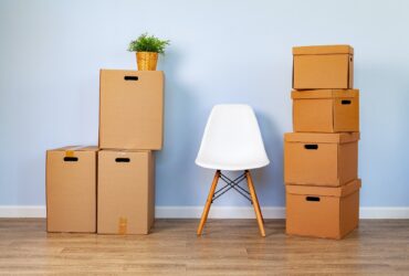 Moving boxes with packed stuff and chair for moving