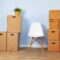 Moving boxes with packed stuff and chair for moving