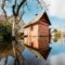 Old wooden Sauna bath building In Water During Spring Flood