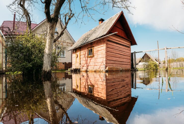 Old wooden Sauna bath building In Water During Spring Flood