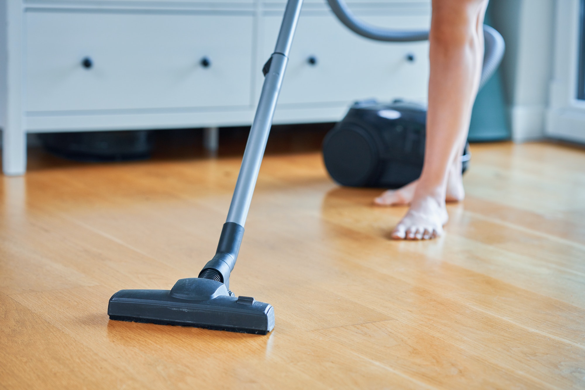 Picture of woman cleaning house using vacuum