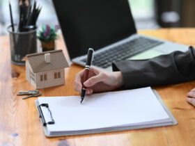 Real estate agent woman analyzing real estate investment data on wooden table.