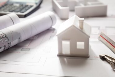 Residential building drawings and house model, Construction concept