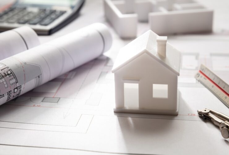Residential building drawings and house model, Construction concept