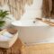 Shot of bathroom with big white bathtub and rustic decor