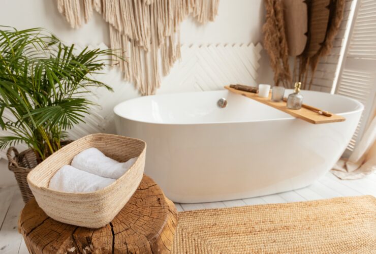 Shot of bathroom with big white bathtub and rustic decor
