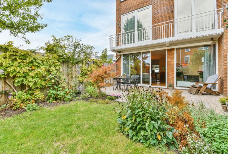 The backyard of a house with a summer dining room