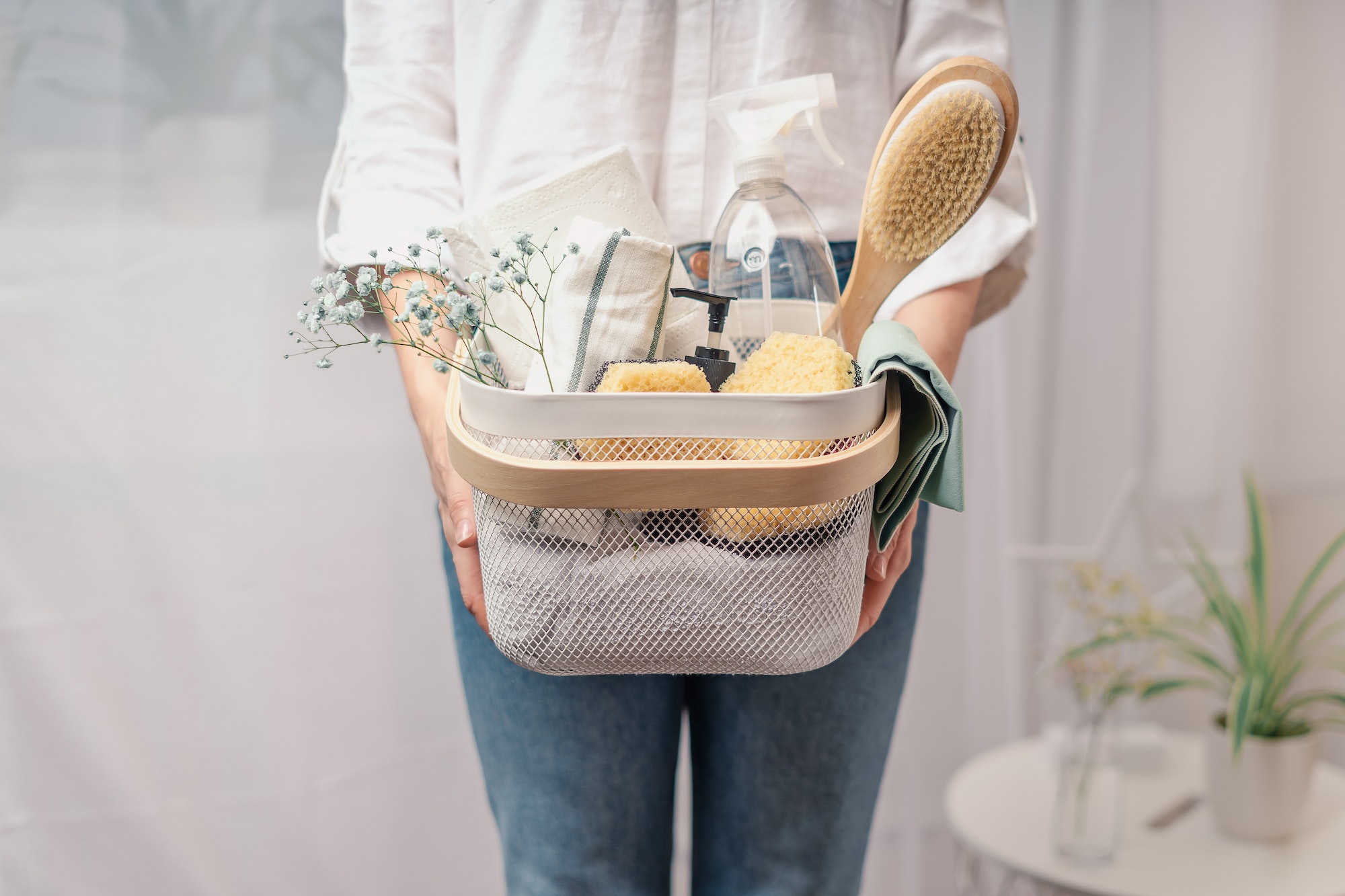 Woman holding basket with cleaning equipment. A woman is doing spring cleaning. The concept of house
